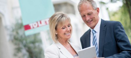 man and woman looking at ipad outside