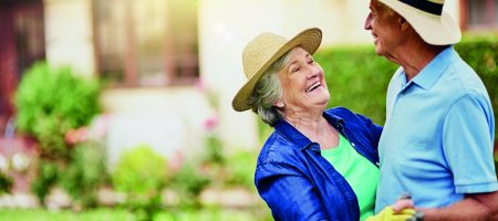 elderly couple dancing outside garden wear