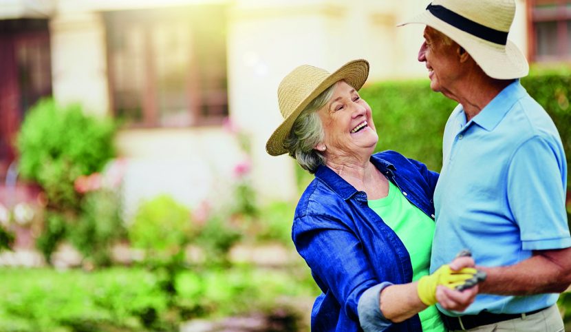 elderly couple dancing outside garden wear