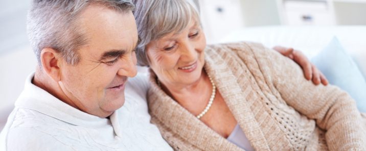 elderly couple man holding woman looking down