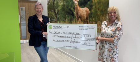 two women holding mansfield cheque deer painting background