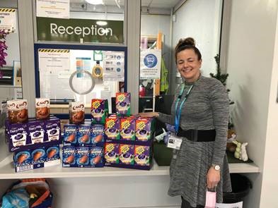 Woman standing next to easter eggs