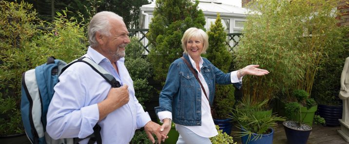 Elderly couple walking in garden