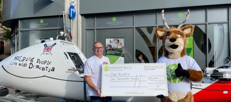 Stanley Stag cheque presentation with rowing boat outside a Mansfield Building Society branch